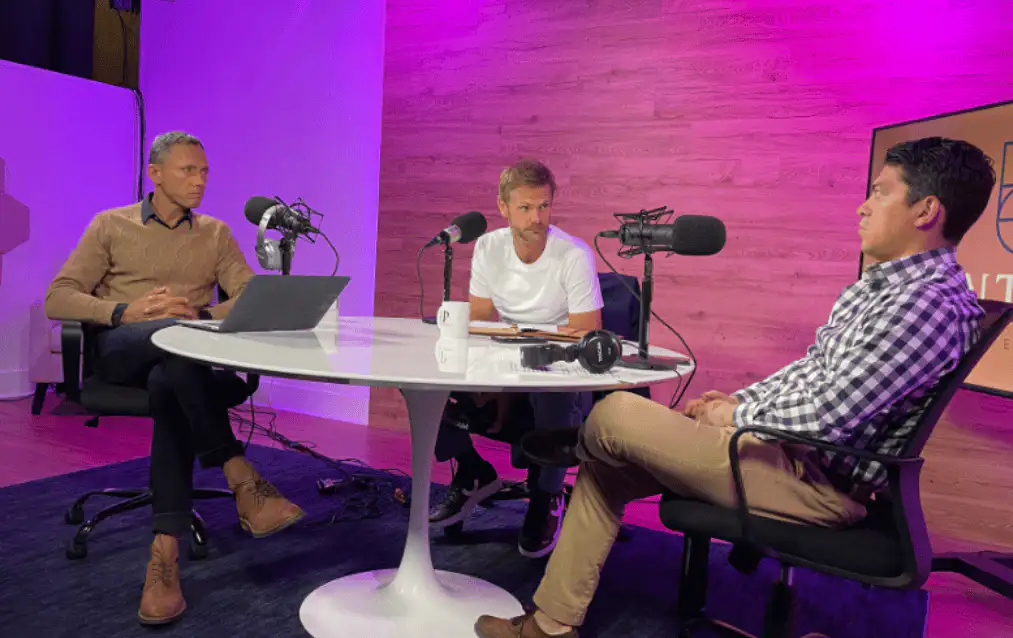 Three guests recording an interview under purple studio lighting at Lobi Space Chicago
