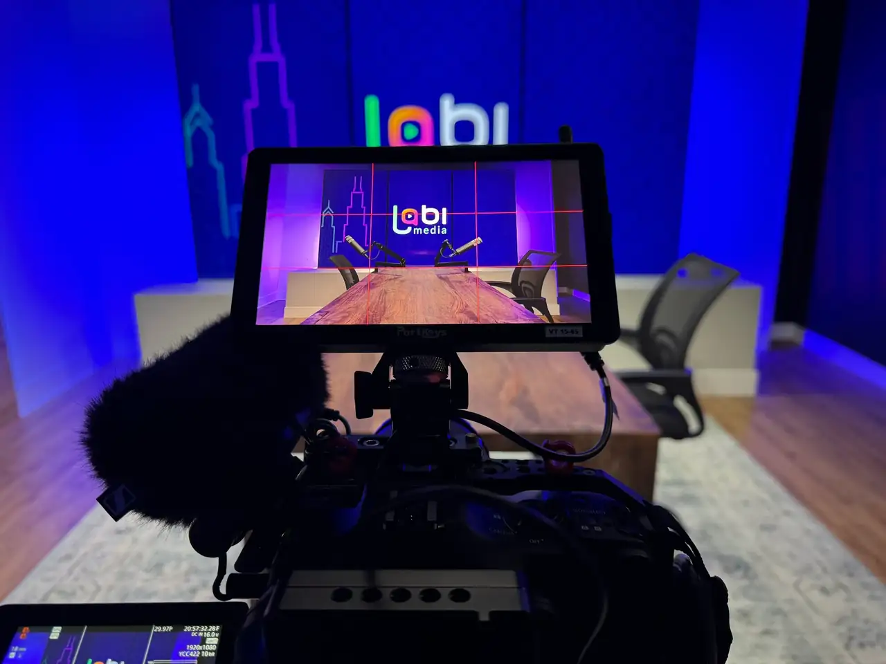 Camera monitor framing the podcast table in the Lobi Space podcast room in Chicago
