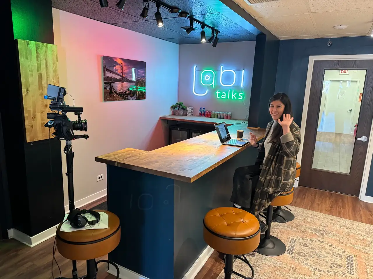 A Lobi Space member working on a laptop at the creator space bar counter in Chicago