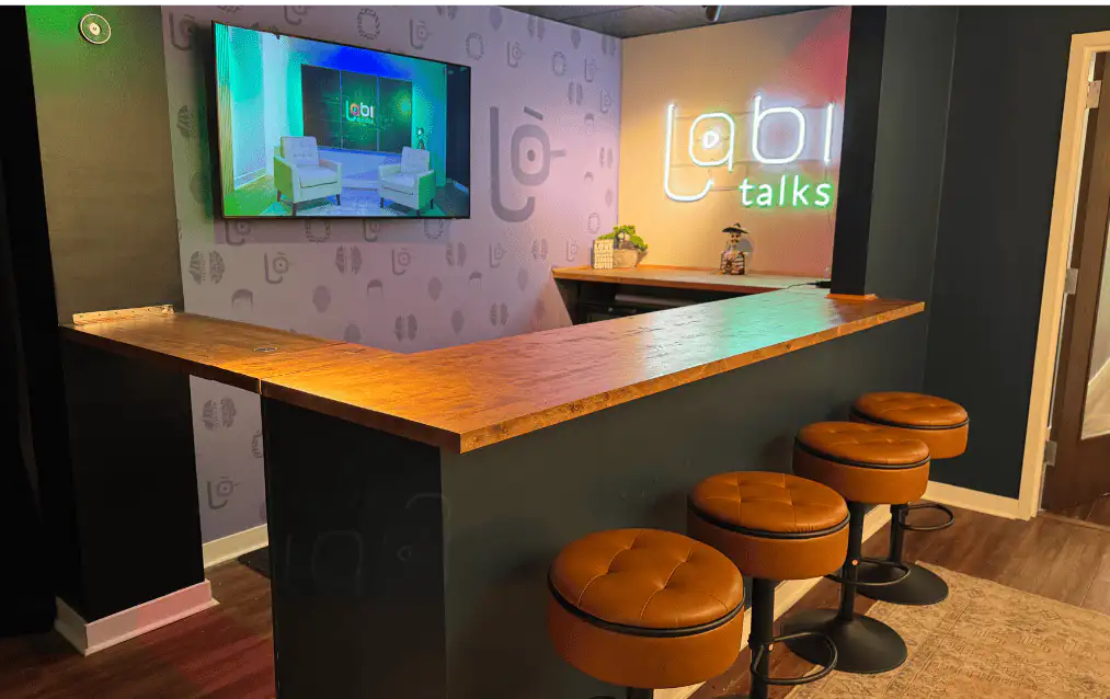 Lobi talks bar with neon sign and lounge seating at Lobi Space Chicago