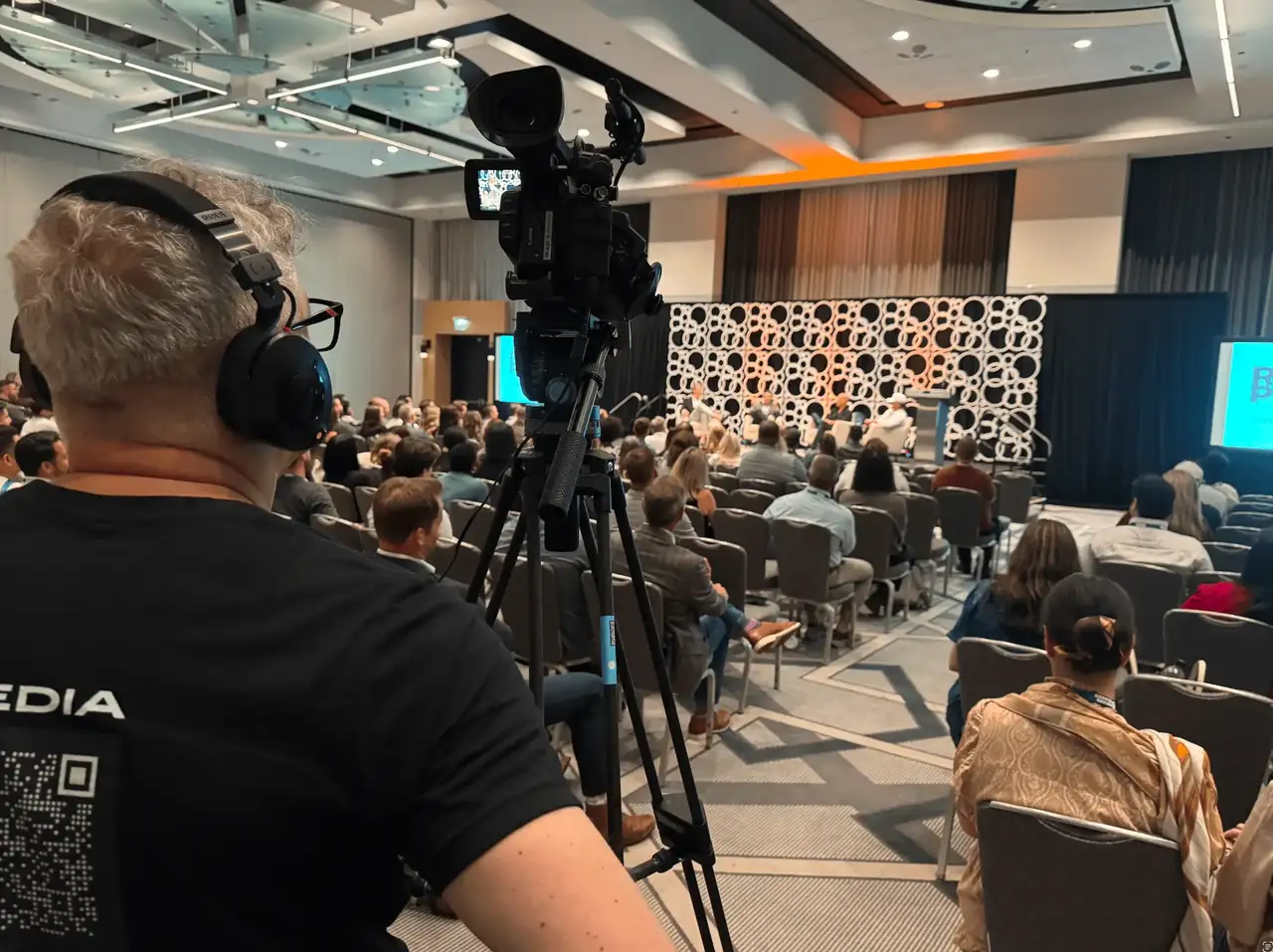 Golden Scope Media camera operator filming a keynote panel for a live event in Chicago