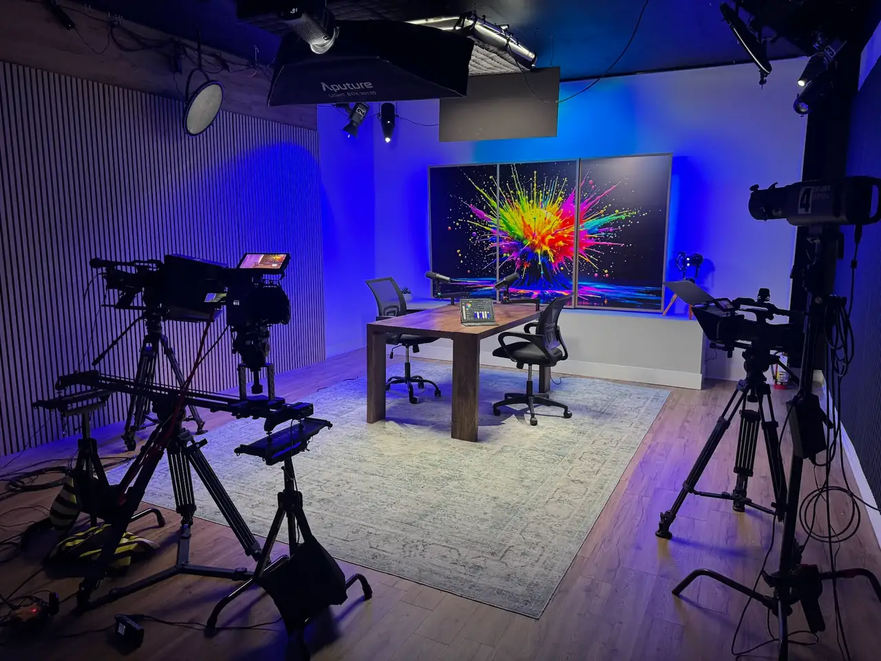 Lobi Space podcast room in Chicago with multiple 4K cameras, Aputure studio lighting, interview table and a colorful LED backdrop